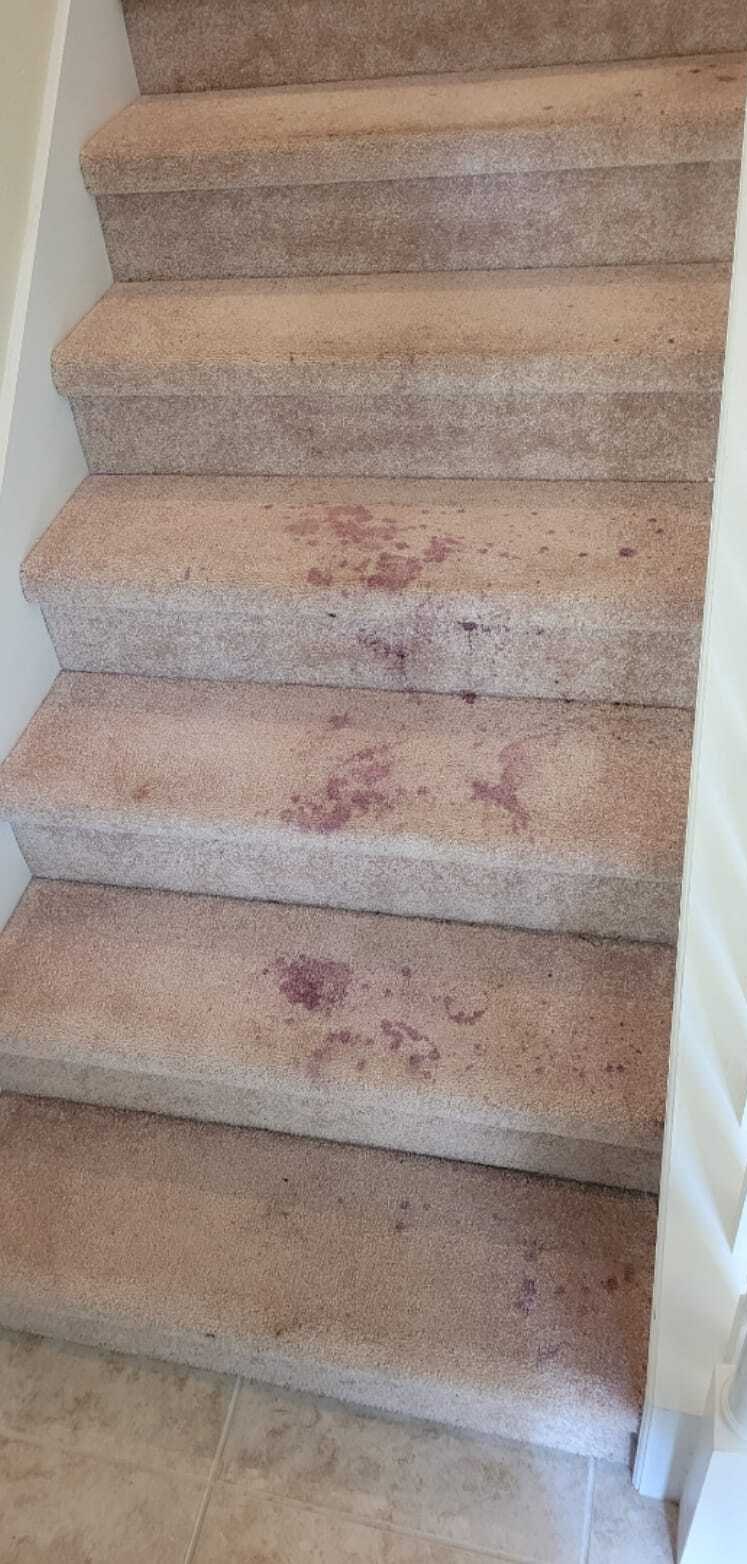 Staircase with wine spills before cleaning